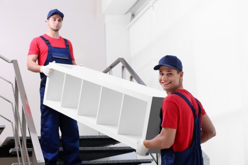 Professional movers handling large furniture during a Brent move