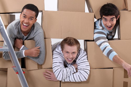Removal staff handling fragile items during a property move