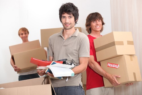 Packed moving boxes and wrapped household items in a flat hallway